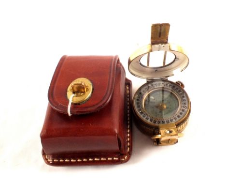 A brass compass (marked London 1941) within a leather case