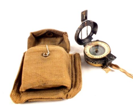 A WWII era compass dated 1939 with its 1941 webbing pouch