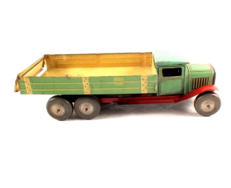 A tin plate British clockwork tipping trunk in green with cream body and red chassis