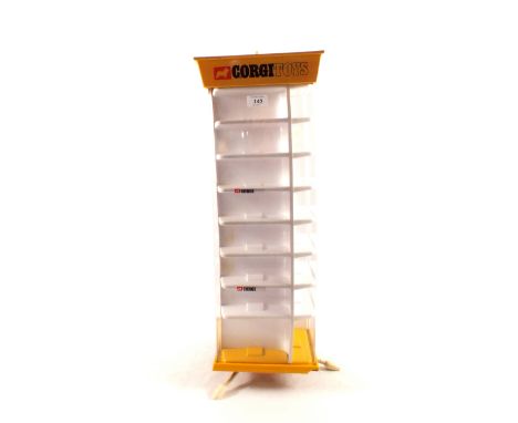 A Corgi rotary shop display stand, plastic and perspex with four columns and thirty two compartments