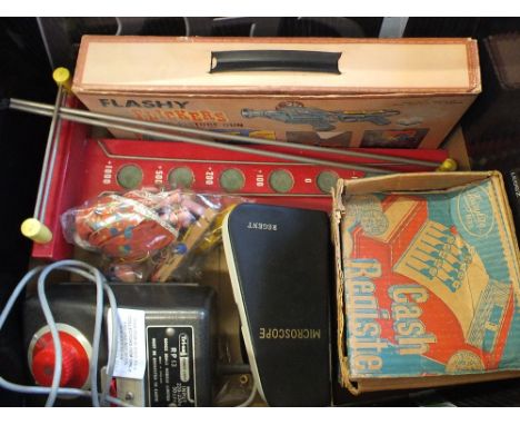 A box of assorted toys including Pelham puppet, mini microscope, roller ball game, childs cash register etc