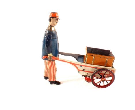 Stock (German) tin plate walking clockwork porter with trolley, c1920 (missing trunk lid)
