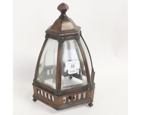 An early 20th century patinated brass framed table lantern, with original curved bevel-glass panels, height 28cmAll in good o