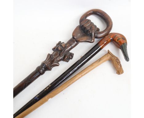 A Russian carved wood walking stick with horse-head handle, signed, an African carved wood walking stick, and 1 other (3) 