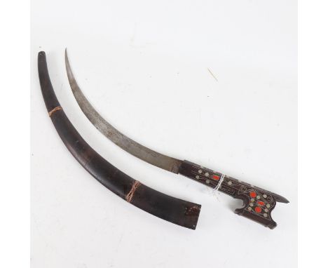 A Persian metal inlaid hardwood curved sword and scabbard, blade length 35cm 