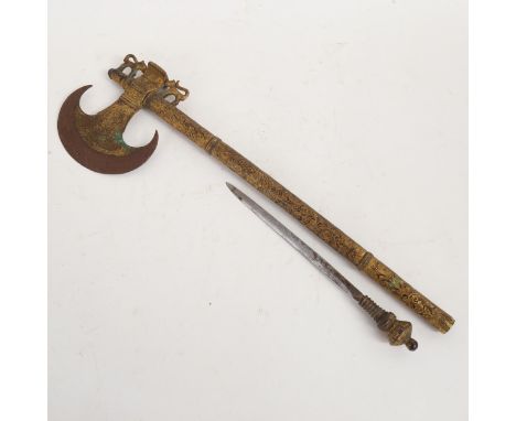 An ornate Indian gilded metal ceremonial axe, probably late 19th century, the handle enclosing a dagger, length approx 45cm 