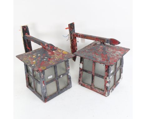 A pair of Vintage painted iron porch lanterns, with mounting brackets (some damage to the glass), height 34cm overall 