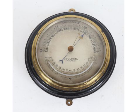 A Victorian aneroid wall barometer, by Dollond of London, with silvered dial, brass bezel and ebonised plaque, overall diamet