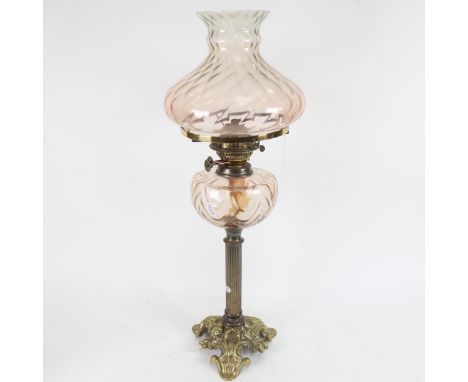 A Victorian brass oil lamp, with pink glass font and shade, height 60cm 