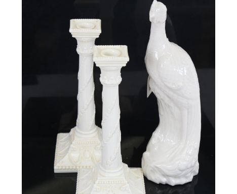 A pair of Royal Worcester 1050 Corinthian column ceramic candlesticks, and a ceramic peacock figure, height 33cm 