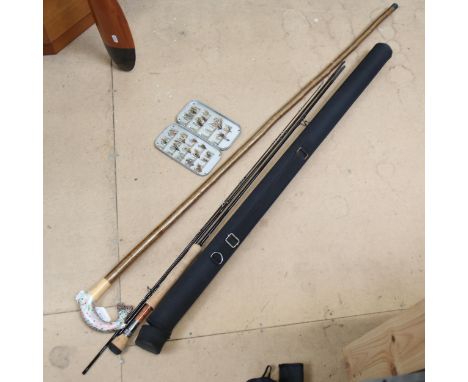 A Wychwood cased fishing rod, and a walking stick 