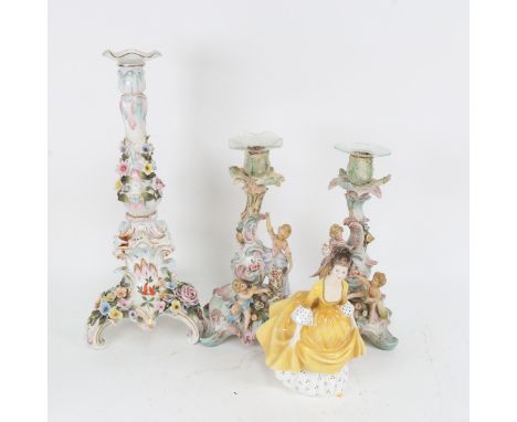 A Continental porcelain candlestick with applied flowers, 36cm, a pair of smaller candlesticks with cherubs, and Royal Doulto