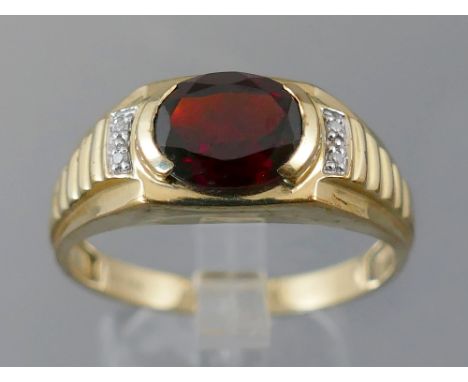 9ct gentleman's signet ring with a central oval cut garnet, approx 2.0ct, flanked by two small diamonds to each shoulder, rin