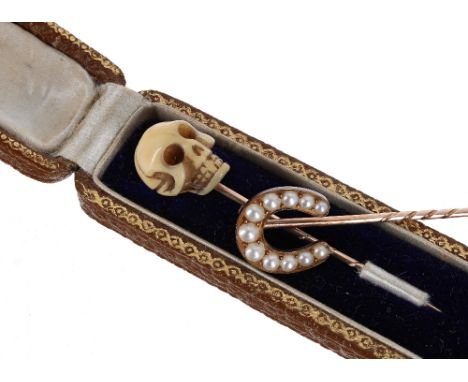 Novelty antique gold and ivory scull stick pin in case, the scull 14mm; also another horseshoe pearl set stick pin (2)