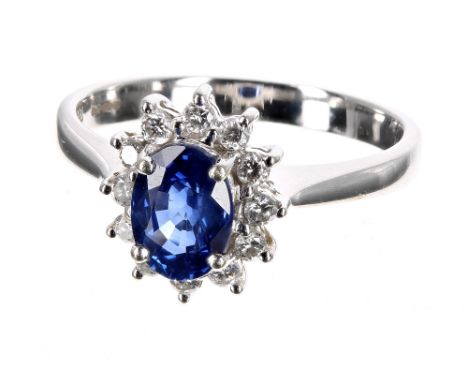 Modern 18ct white gold sapphire and diamond oval cluster ring, the sapphire of good colour in a surround of round brilliant d