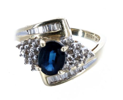 14ct sapphire and diamond cross over ring, the sapphire 0.80ct approx, in a diamond setting of round and baguette-cut diamond