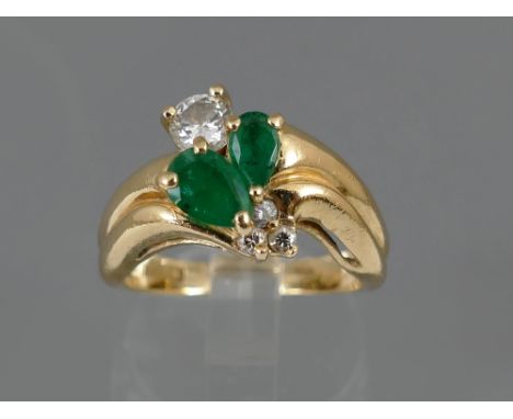 Modern 14ct emerald and diamond ring, the two central pear-shaped emeralds, 0.50ct approx, with a single round cut diamond, 0