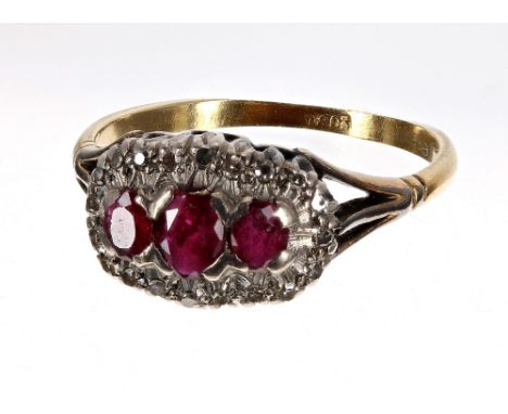 18ct ruby and diamond boat shaped cluster ring, with three oval rubies in a diamond claw setting, 10mm x 14.5mm, 5.4gm, ring 