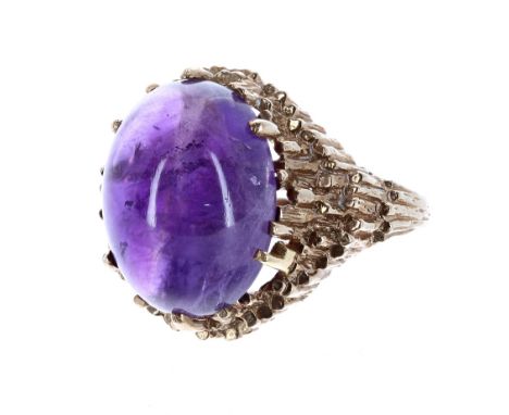 9ct amethyst cabouchon ring in the manner of Andrew Grima, London 1970, the amethyst 16mm x 12mm, 7.4gm, ring size Q