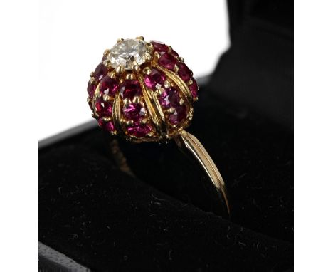 18ct domed ruby and diamond cluster ring, the diamond 0.50ct approx, clarity VS, colour J-K, in a surround of twenty-four sma