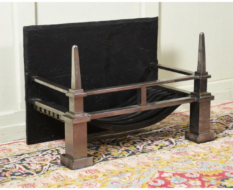 A POLISHED STEEL AND CAST IRON FIRE GRATE  20TH CENTURY The polished steel front of spire form 45cm high, 61cm wide, 36cm dee
