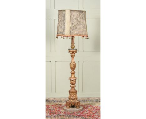 AN ITALIAN GILTWOOD ALTAR CANDLESTICK  LATE 18TH CENTURY AND LATER  Now fitted as a standard lamp and with a metallic thread 