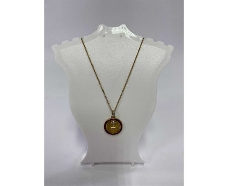 DIAMOND &amp; RUBY SET CIRCULAR PENDANT on a nine carat gold fine link necklace, the pendant unmarked but believed gold, 12mm