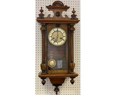 CIRCA 1900 VIENNA TYPE WALNUT CASED WALL CLOCK having Roman numerals set against enamel, before a pendulum driven chime strik