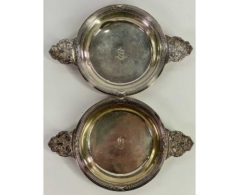 FRENCH SILVER BOTTLE COASTERS / DISHES, A PAIR, French Minerva head standard mark, having ribbed upper rims and twin handles,