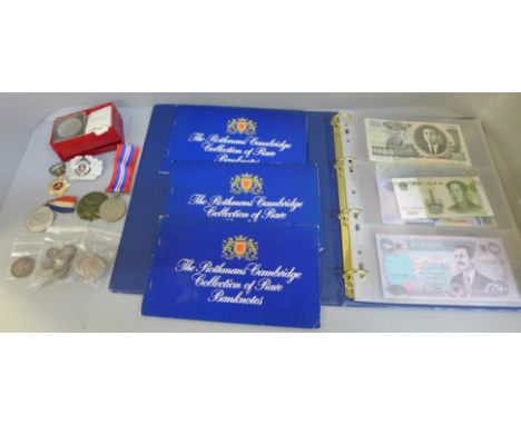 A collection of foreign banknotes, commemorative coins, silver half dollar and medals and a replica German ring 