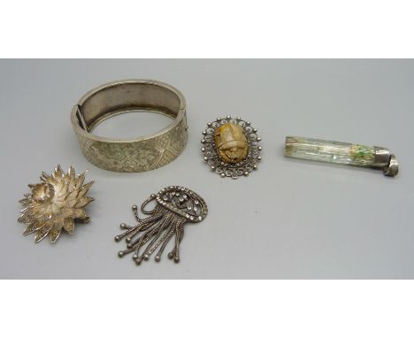 A bangle, two brooches, a tassel and a silver mounted pendant 