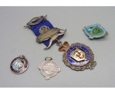 A silver RAOB medal, one other silver medal and two silver and enamel badges 