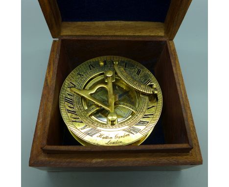 A modern compass in a wooden box 