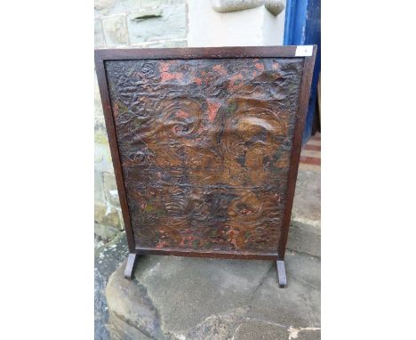 An oak firescreen, mounted with an antique polychrome decorated embossed leather panel