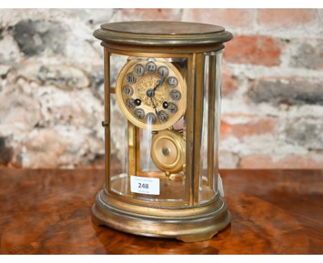An oval lacquered brass cased four glass mantel clock, the eight-day movement with Arabic numeral dial and striking on a coil