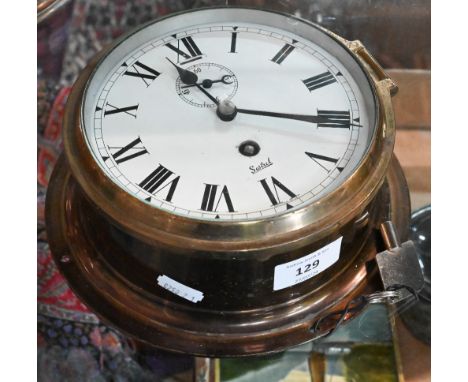 A lacquered brass Sestrel ship's clock with 14 cm enamel dial 