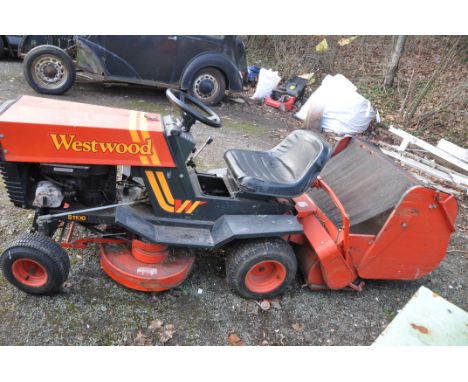 A VINTAGE WESTWOOD S1100 RIDE ON LAWN MOWER with grass collection box and one key, battery flat, tries to start but hasn't st