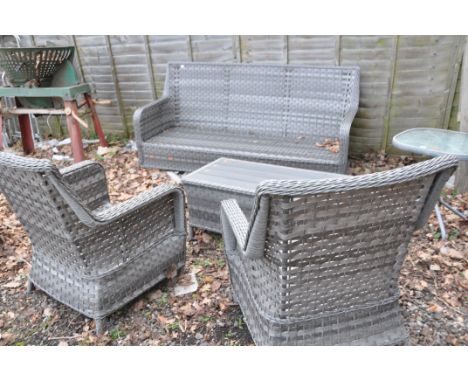 A MODERN GREY RATTAN EFFECT CONSERVATORY SUITE consisting of a three seat sofa, two chairs and a coffee table grey seat cushi