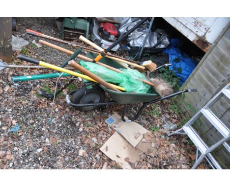 A PLASTIC BUILDERS WHEELBARROW, containing garden tools