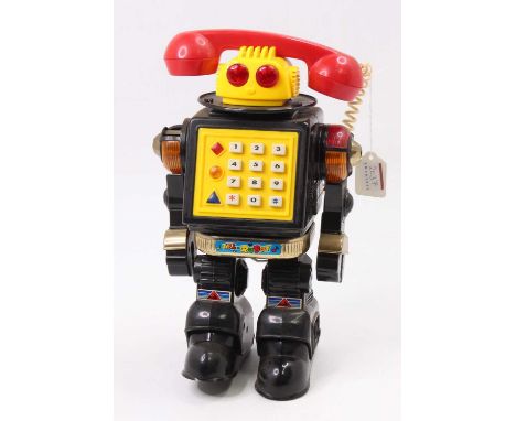 Made in Taiwan plastic and battery operated model of Tel-Robot, black body with yellow head and red eyes, red telephone, with