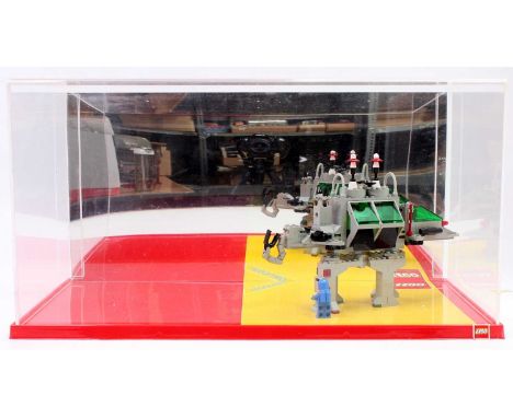 An original 1980s Lego shop display diorama, comprising of red base with perspex case and mirrored back, containing one model