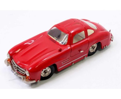 A Marklin modern issue tinplate and clockwork No. 1092 Mercedes 300 SL Gullwing in red with a cream interior and steerable fr