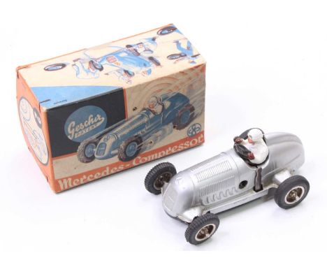 A Gescha No. 1 tinplate and clockwork model of a Mercedes Kompressor race car, comprising of silver body with white driver, h