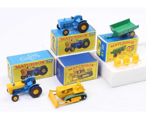 Four various boxed Matchbox Regular Wheels diecasts to include a No. 18 Caterpillar bulldozer, a No. 51 tipping trailer, a No