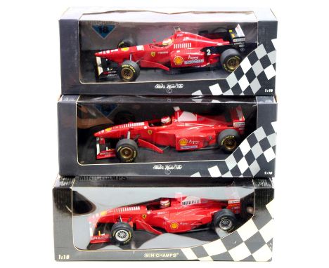 A Minichamps/Pauls Model Art 1/18 scale boxed Ferrari F1 race car group to include an E Irvine Ferrari F300 F1 car, an E Irvi