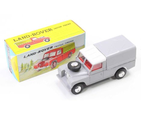 A Jimson No. 115, plastic and friction drive model Landrover comprising of grey body with white roof and red interior, housed