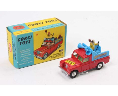 Corgi Toys No. 487 Chipperfields Circus Land Rover Parade vehicle, red body with blue back, standing figure, and monkey figur