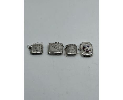 A Collection Of Four Silver Match Stick Cases-  To Include Floral Patterns, An Enamel Picture Of A Pug And Other 