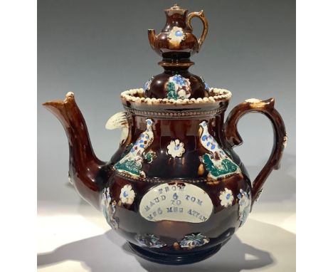 A late 19th century barge ware teapot, treacle glaze, "From Maud and Tom to Mr and Mrs Attan", domed cover with teapot finial