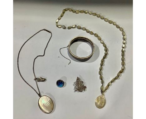 A silver bangle, Birmingham 1947; a silver butterfly brooch, marked 925; a mother of pearl necklace and pendant; etc 